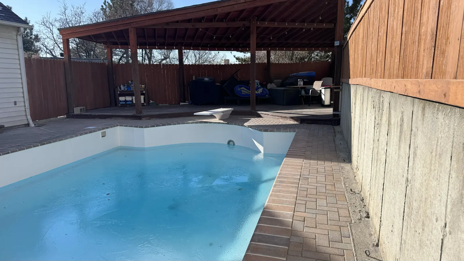 Backyard pool with paver deck and pergola