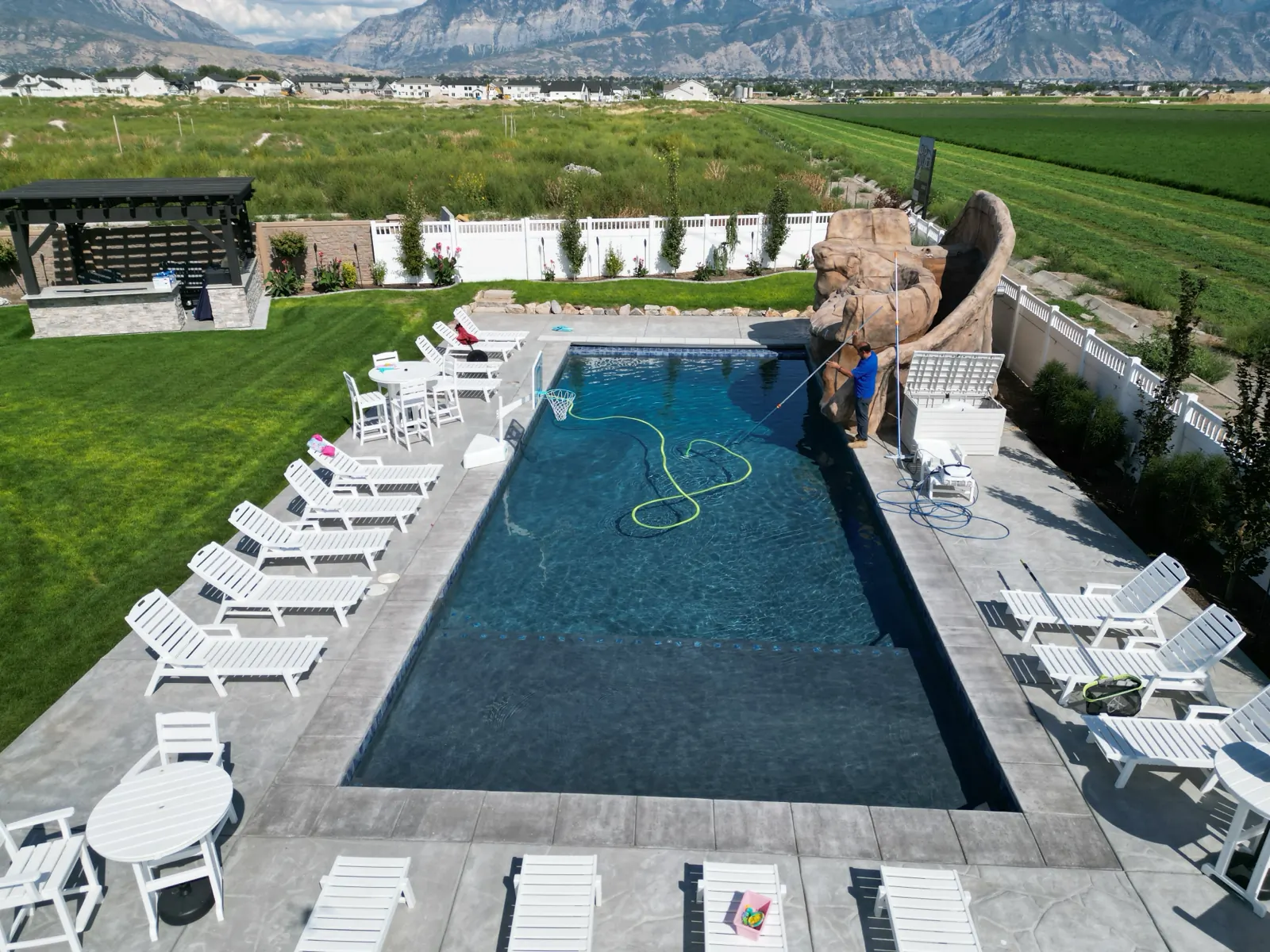 Aerial view of a backyard pool below the Wasatch mountains